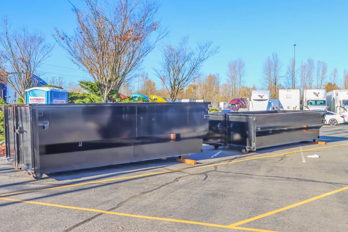 Professional dumpster rental service with roll-off container on residential driveway in Kennebunk